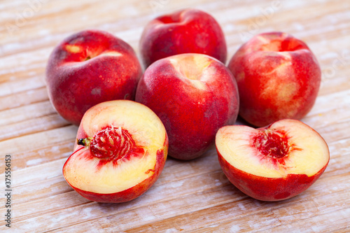 Fresh juicy peaches on wooden background, harvest season