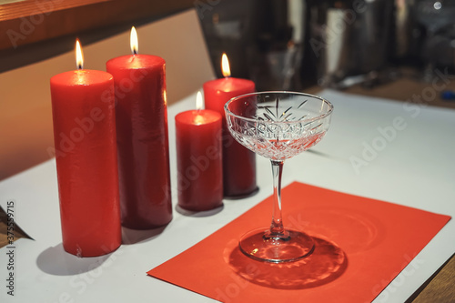 Red candles and glasses. table setting