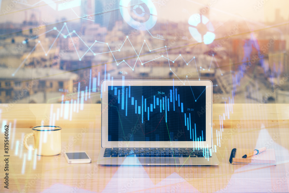 Financial graph colorful drawing and table with computer on background. Double exposure. Concept of international markets. Financial graph colorful drawing and table with computer on background. Double exposure. Concept of international markets.