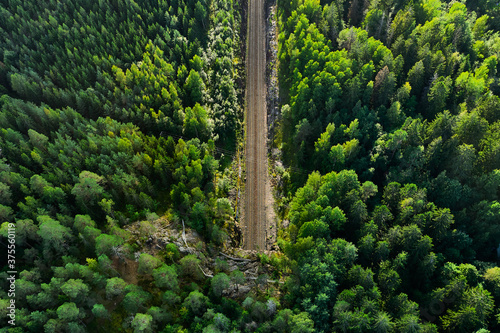 Obraz na płótnie Aerial view of the railway track. The railroad between the hills goes into a tunnel. w salonie