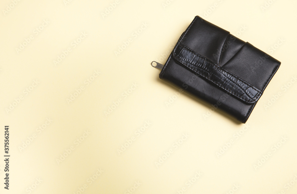 Womans wallet on an isolated yellow background. Womans wallet on an isolated yellow background.