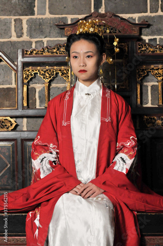 Chinese maiden in ancient Hanfu with delicate silver hairpin on her hair decoration,in elegant and noble temperament, with background of Chinese classical gardens and indoor carved wood furniture, lux