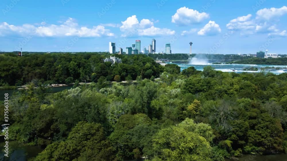 Aerial backwards shot of Niagara Falls, skyscraper skyline and rural forest with trees on canadian border. Aerial backwards shot of Niagara Falls, skyscraper skyline and rural forest with trees on canadian border.
