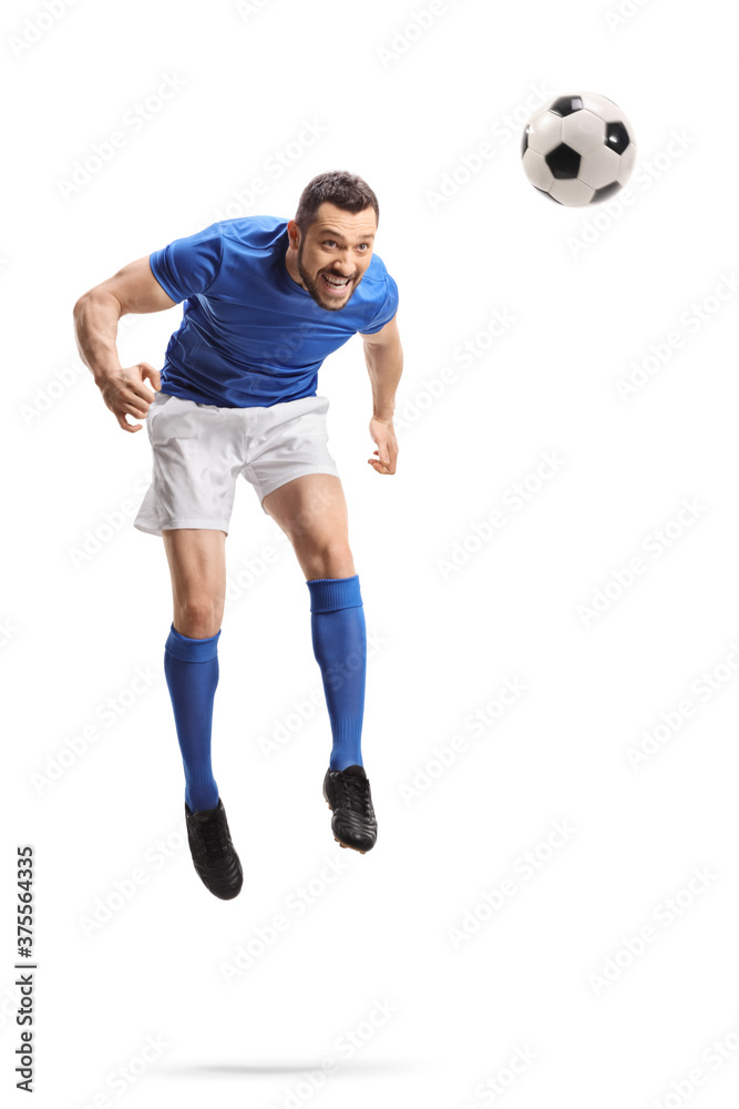 Full length portrait of a footballer jumping and hitting a ball with head Full length portrait of a footballer jumping and hitting a ball with head