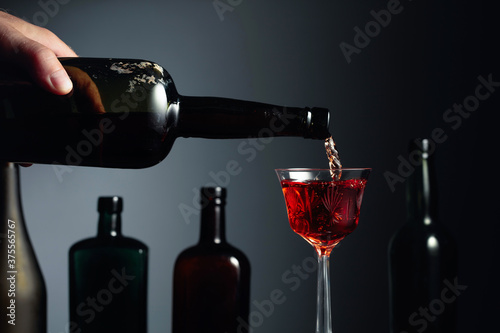 Aged golden fortified sherry being poured into a crystal glass.