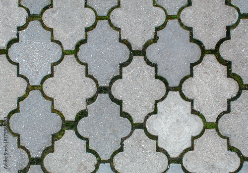 road paved with sidewalk tiles. texture of light gray bricks.