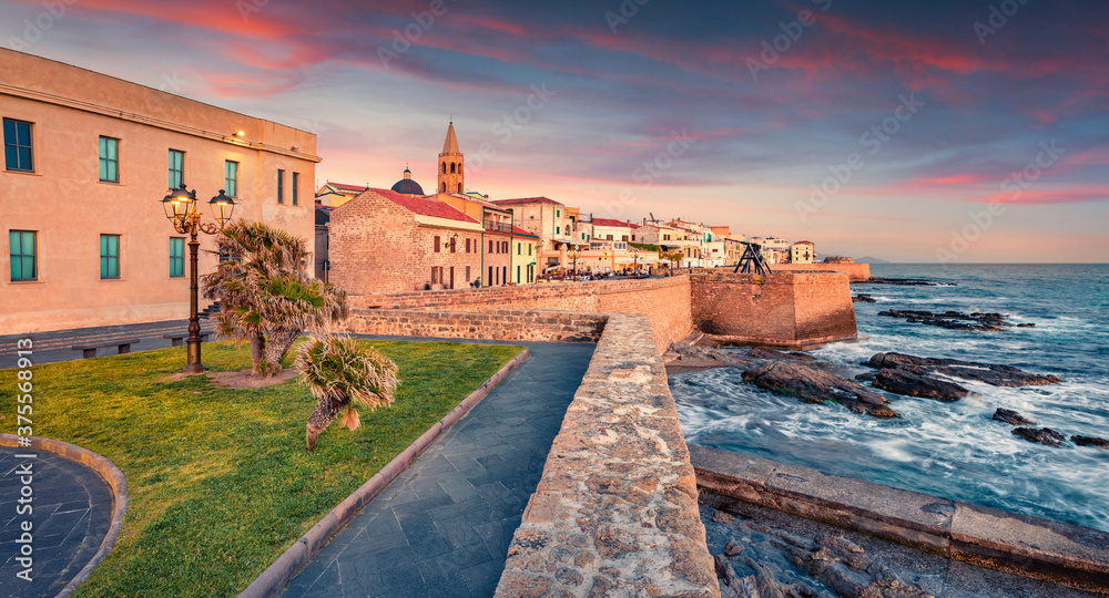Empty street at evening in old fortress of  Alghero, Province of Sassari, Italy, Europe.   summer sunset on Sardinia island, Mediterranean seascape. Traveling concept background.