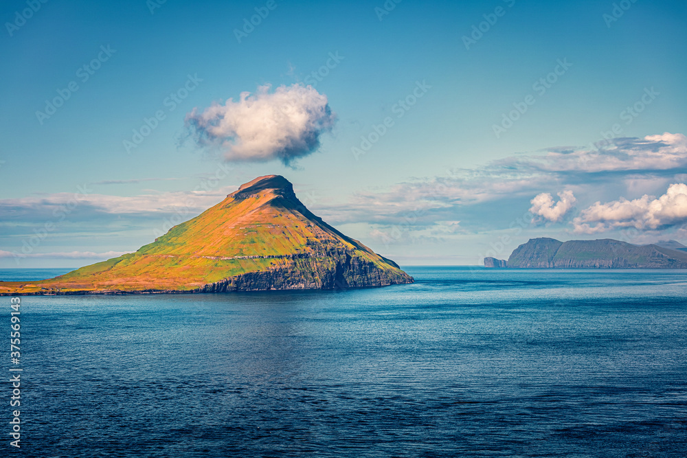 Sunny summer view of Koltur island. Picturesque morning scene of Faroe Islands, Kingdom of Denmark, Europe. Wonderful seascape of Atlantic ocean. Beauty of nature concept background.. Sunny summer view of Koltur island. Picturesque morning scene of Faroe Islands, Kingdom of Denmark, Europe. Wonderful seascape of Atlantic ocean. Beauty of nature concept background..