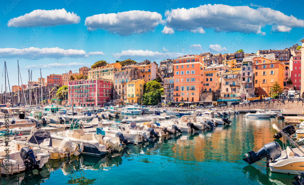 Attractive summer cityscape of Bastia port. Marvelous morning view of Corsica island, France, Europe. Wonderful Mediterranean seascape with yacht and lighthouse. Traveling concept background.