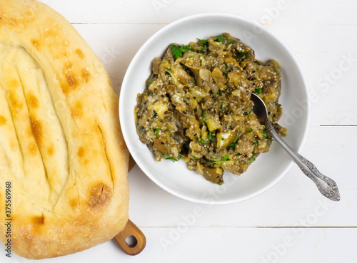 Eggplant baba ganoush with flat bread and herbs photo