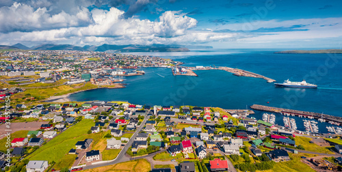 Panoramic summer view from flying drone of Torshavn town. Aerial morning scene of Streymoy island, Faroe, Denmark, Europe. Traveling concept background.