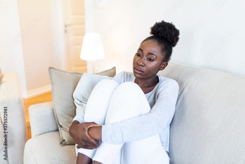People, emotions, stress and health care concept - unhappy african american young woman touching her head and suffering from headache People, emotions, stress and health care concept - unhappy african american young woman touching her head and suffering from headache