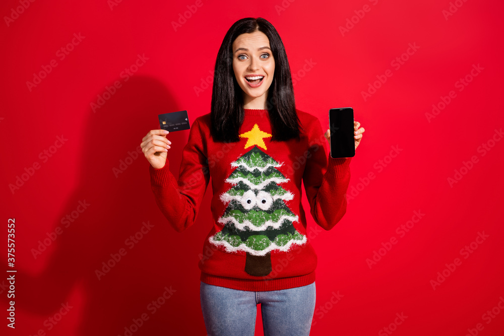Portrait of her she nice attractive glad cheerful cheery girl holding in hand plastic bank card gadget use app buy delivery fast shipping isolated bright vivid shine vibrant red color background Portrait of her she nice attractive glad cheerful cheery girl holding in hand plastic bank card gadget use app buy delivery fast shipping isolated bright vivid shine vibrant red color background