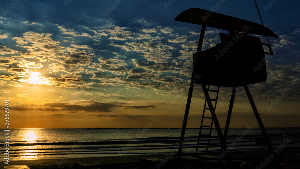 Silhouette of lifeguard tower with beautiful sunshine on the beach Silhouette of lifeguard tower with beautiful sunshine on the beach