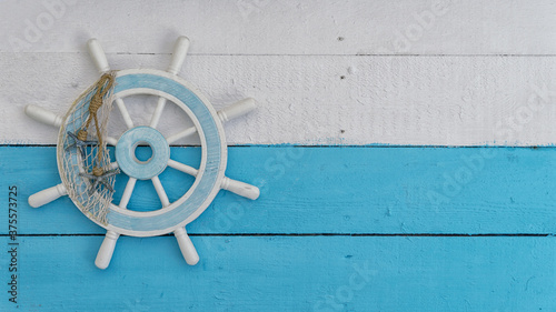 Flat lay of tiller boat sail steering wheel on white and blue wooden background sailing marin copy space