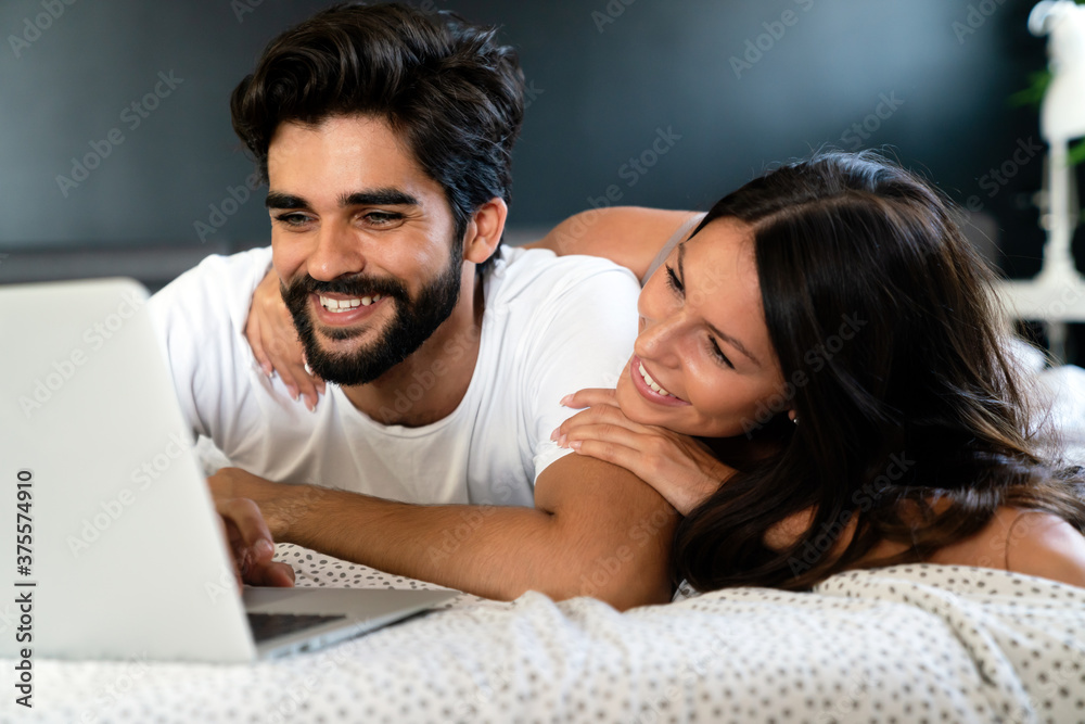 Romantic happy couple in love relaxing at home having fun. People technology concept. Romantic happy couple in love relaxing at home having fun. People technology concept.