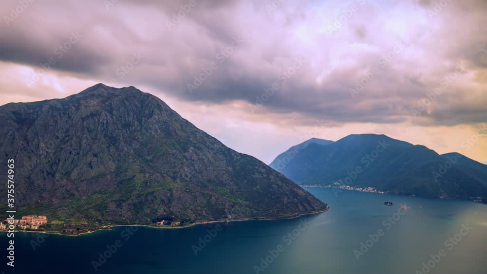 Boka Kotor Bay, before rain, clouds move smoothly across the sky, amid large mountains, for which clouds cling. Timelapse made in early spring Boka Kotor Bay, before rain, clouds move smoothly across the sky, amid large mountains, for which clouds cling. Timelapse made in early spring