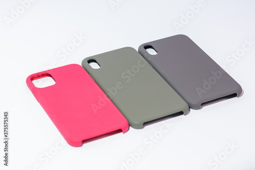 Cases for smartphones in different colors on a white background