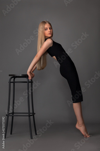 teen girl in black tight dress