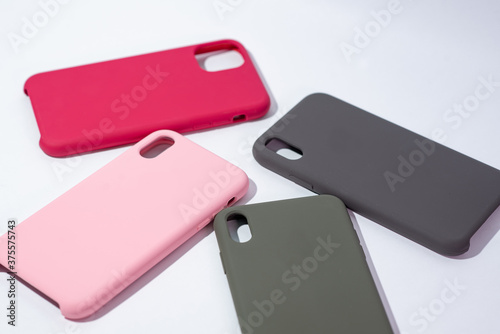 Cases for smartphones in different colors on a white background