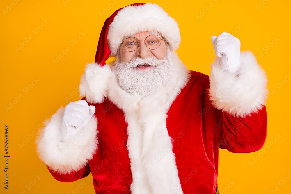 Photo of ecstatic santa claus raise fists win magic miracle fairy north-pole lottery wear style stylish trendy red costume cap headwear isolated over bright shine color background