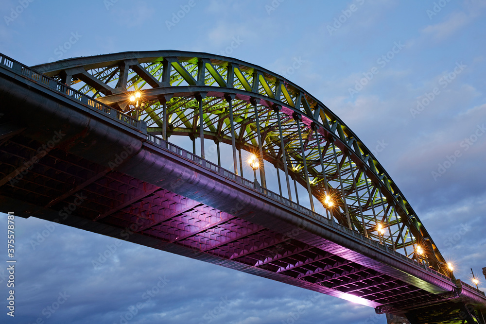 Architectural detail of the Tyne Bridge spanning the River Tyne in Newcastle illuminated at dusk