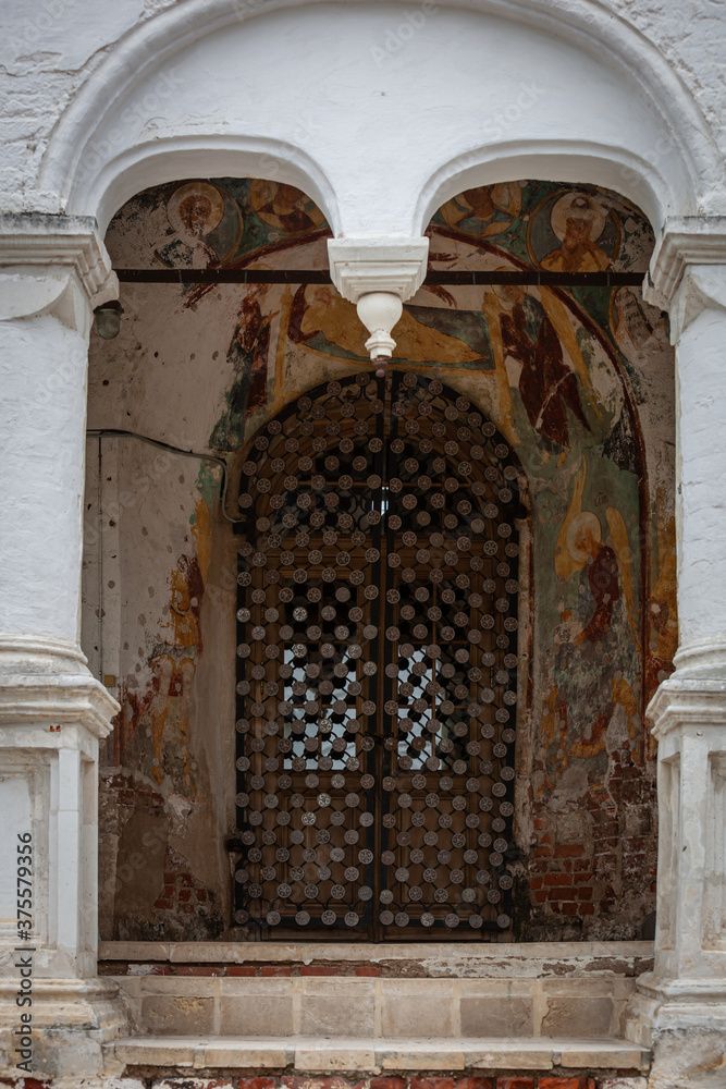 Russian church portal with bronze gate and fresco