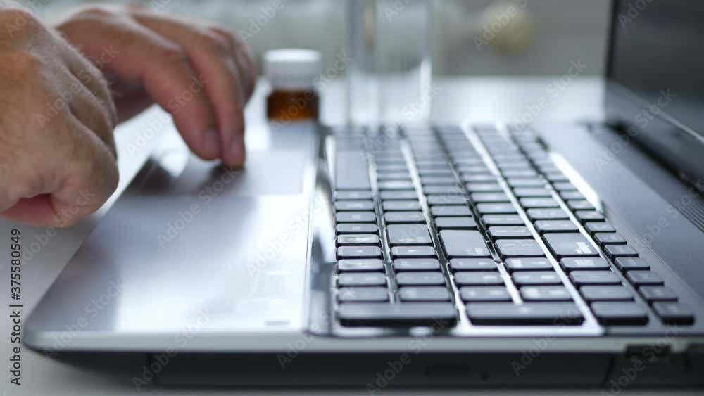 Businessman Typing on a Laptop Keyboard Accessing Internet Working Remotely with Social Isolation in Coronavirus Pandemic Businessman Typing on a Laptop Keyboard Accessing Internet Working Remotely with Social Isolation in Coronavirus Pandemic