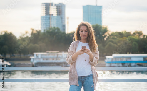 Young woman using phone outside stock photo © Tijana