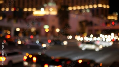 Defocused fabulous Las Vegas Strip boulevard, luxury casino and hotel, gambling area in Nevada, USA. Nightlife and traffic near Fremont street in tourist money playing resort. Neon lights of sin city.