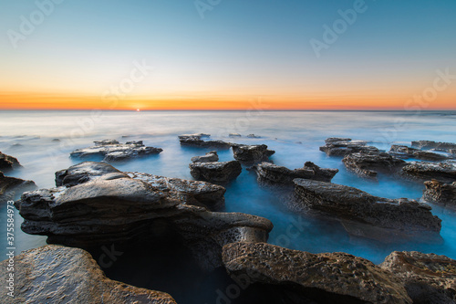 Sunrise view around the rocky platform at Coalcliff Beach, Sydney, Australia.