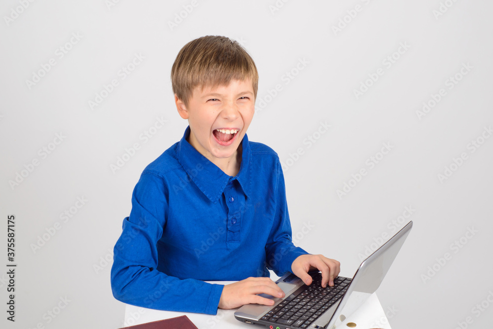the little hacker: a Young smart boy with a netbook mentally hap the little hacker: a Young smart boy with a netbook mentally hap