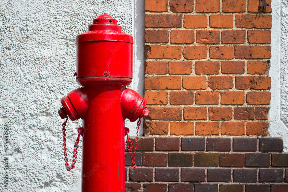 old red fire hydrant against the brick wall old red fire hydrant against the brick wall