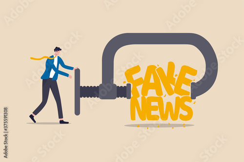 Stop fake news and misinformation spreading on internet and media concept, businessman leader squeezing and destroy the word fake news.