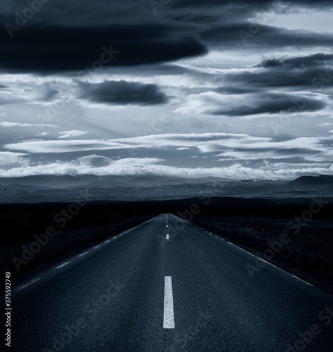 empty road and clouds on th...