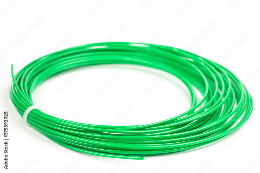 Top view of green rolled filament plastic for 3D Printing Pen isolated on white. Top view of green rolled filament plastic for 3D Printing Pen isolated on white.