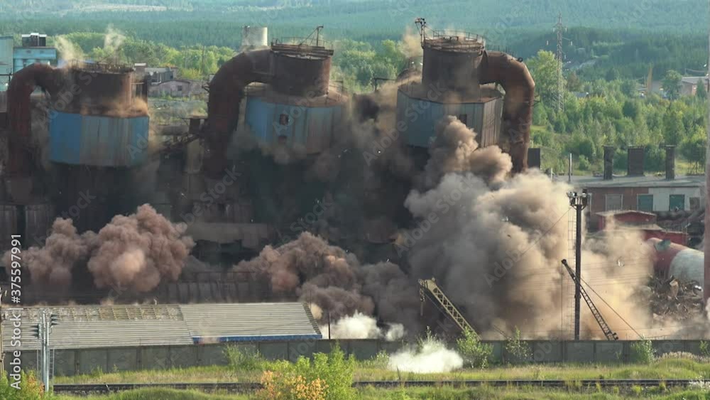 The collapse of an obsolete industrial chimney with an explosion. Disposal of an obsolete metallurgical plant.