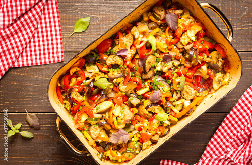 Stewed vegetables in an bowl, eggplant with zucchini and tomatoes, sweet and hot peppers and spices, canned peas, mixing of Ratatouille ingredients in a bowl photo