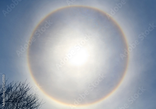 Beautiful sun halo phenomenon with circular rainbow, solar halo the ring is caused by sunlight passing through ice crystals through cirrus clouds