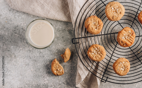 Gluten free homemade oatmeal cookies and oat milk on a light background.