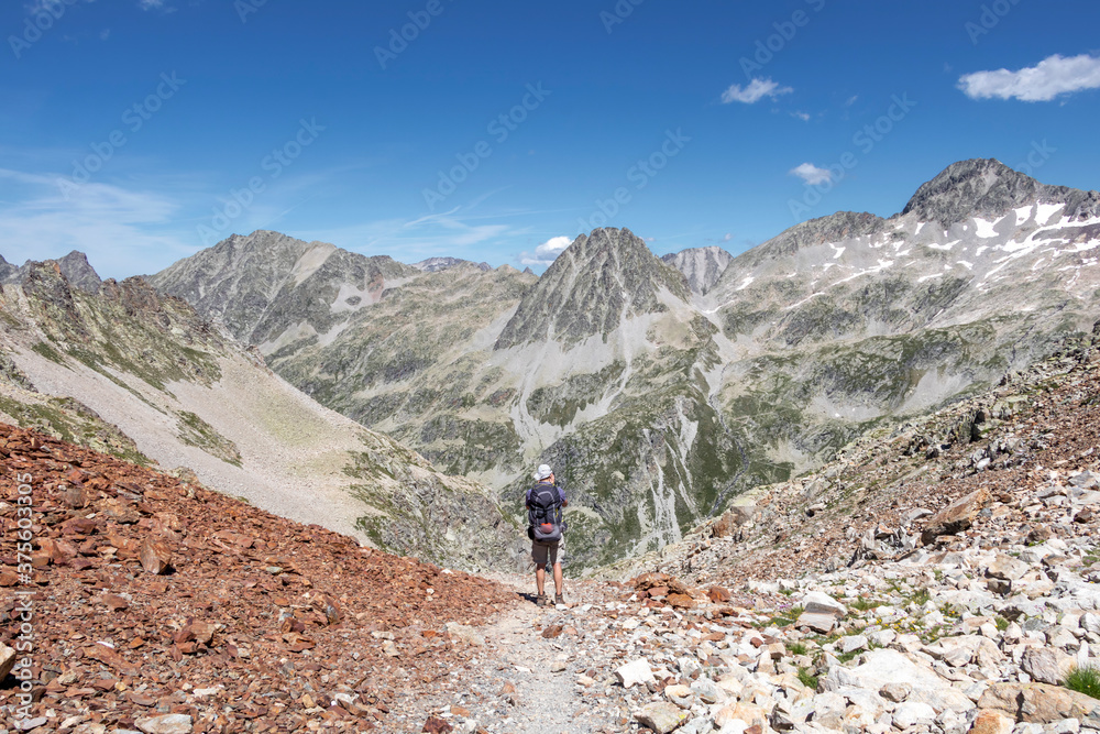 Man hiking in mountains. Hiking in Pyrenees National Park, Hautes-Pyrenees, Occitanie in south of France France