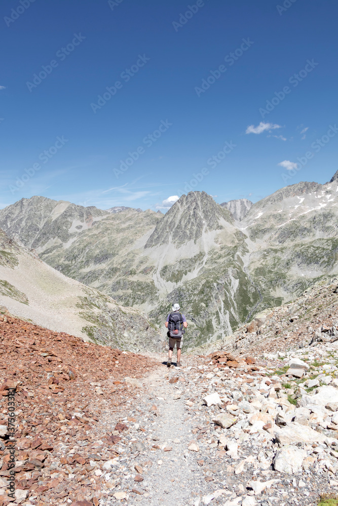 Man hiking in mountains. Hiking in Pyrenees National Park, Hautes-Pyrenees, Occitanie in south of France France