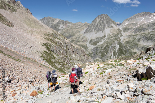 Hikers walking in Pyrenees National Park, Hautes-Pyrenees, Occitanie in south of France