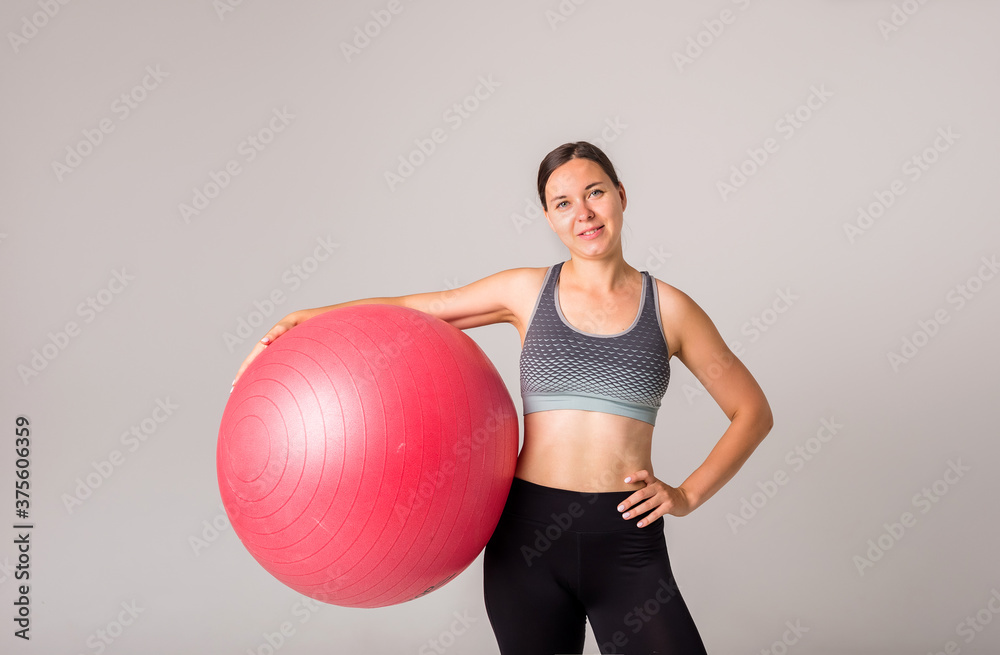 portrait of a sporty girl with a fitness ball on a white background with a copy of the space portrait of a sporty girl with a fitness ball on a white background with a copy of the space