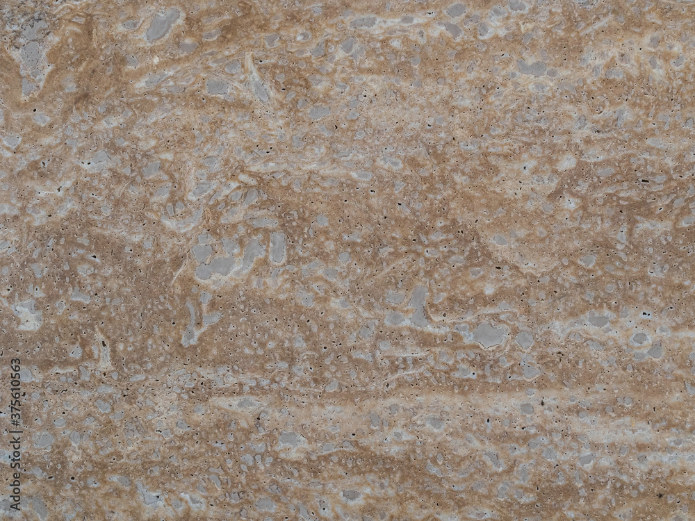 beige granite wall with gray stains - texture