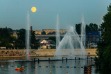 Evening view to Musical fountain with laser animations Roshen on the Southern Buh river in Vinnytsia, Ukraine.