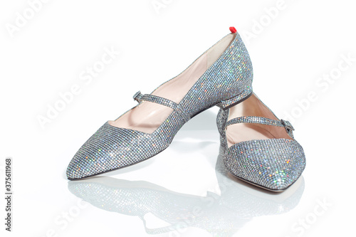 Elegant flat female shimmering shoes isolated on a white background.