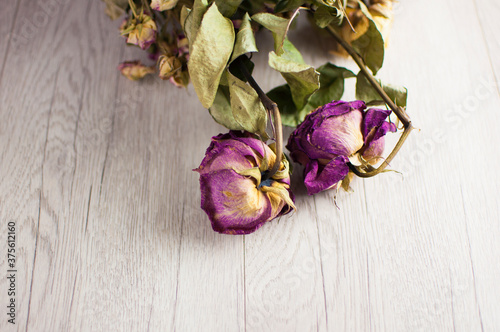 bouquet dried roses on old wood background with copy space