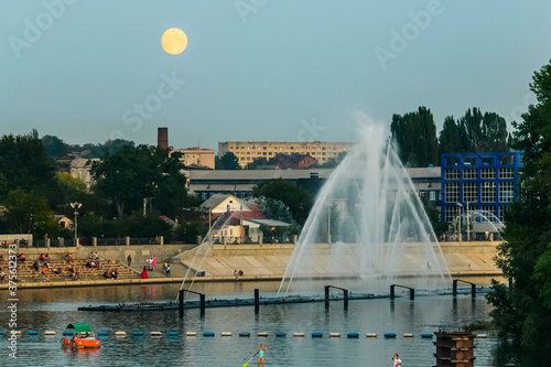 Evening view to Musical fountain with laser animations Roshen on the Southern Buh river in Vinnytsia, Ukraine. photo