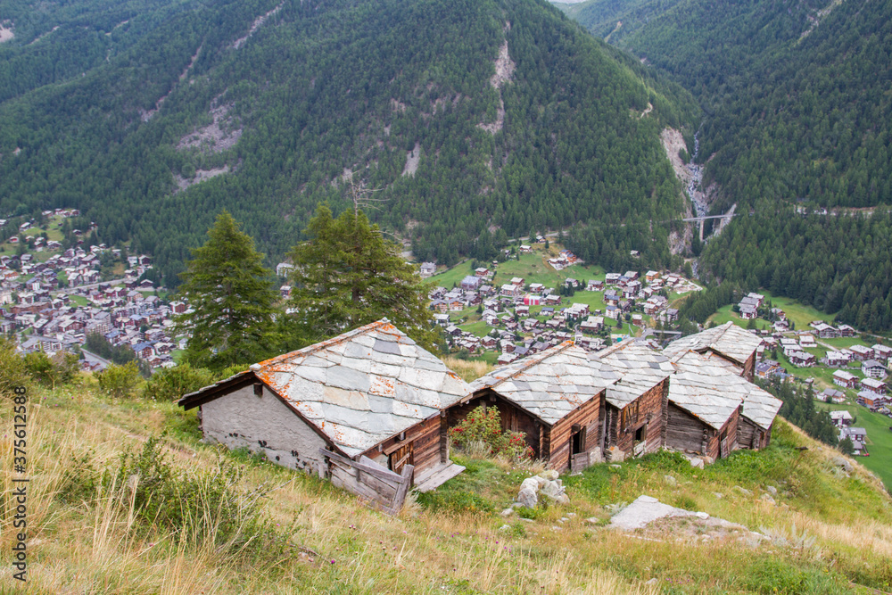 View of Zermatt with traditional huts with roof with slate bricks, Switzerland